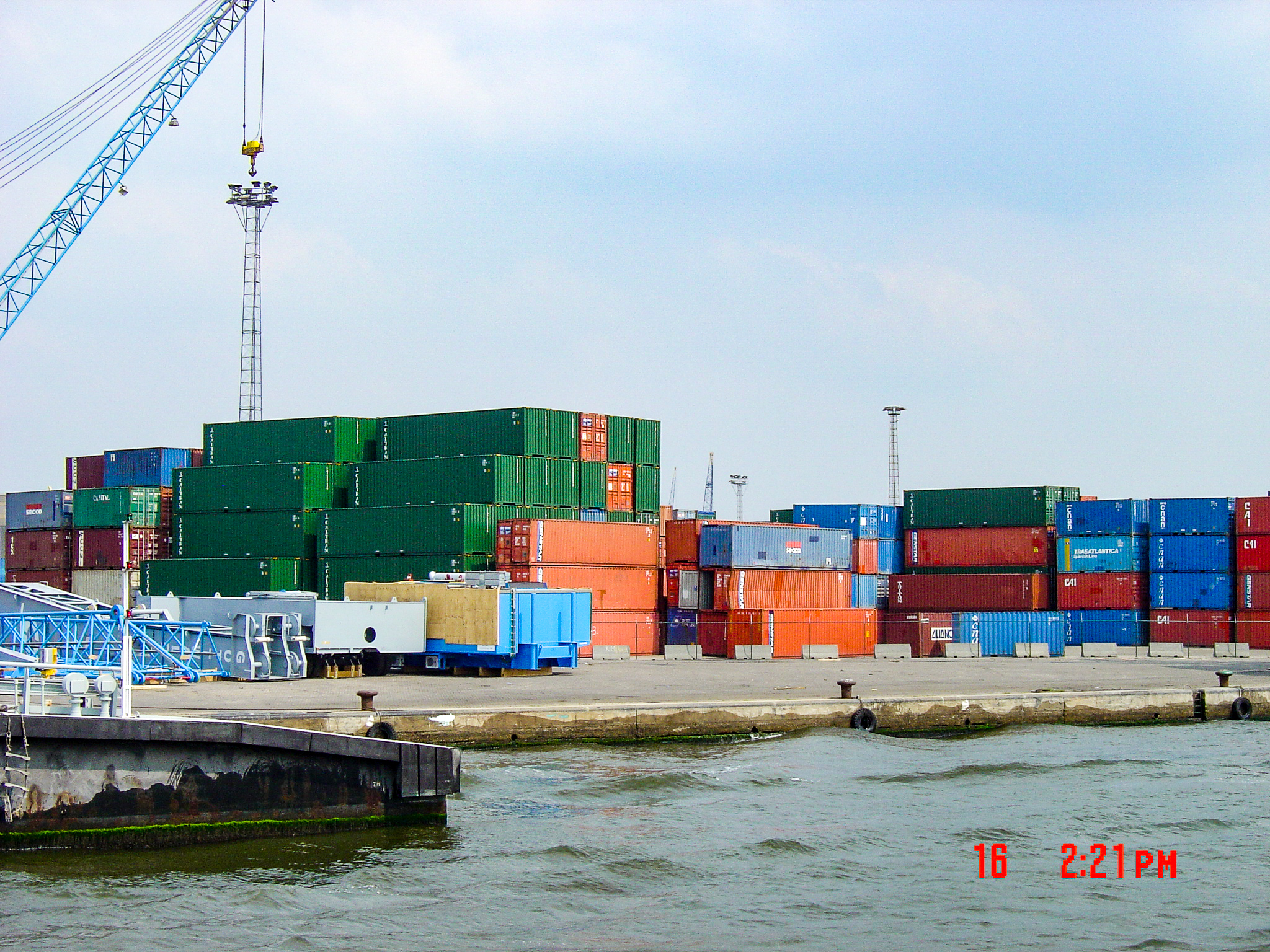 Containers and quay equipment beside the water in the Port of Antwerp