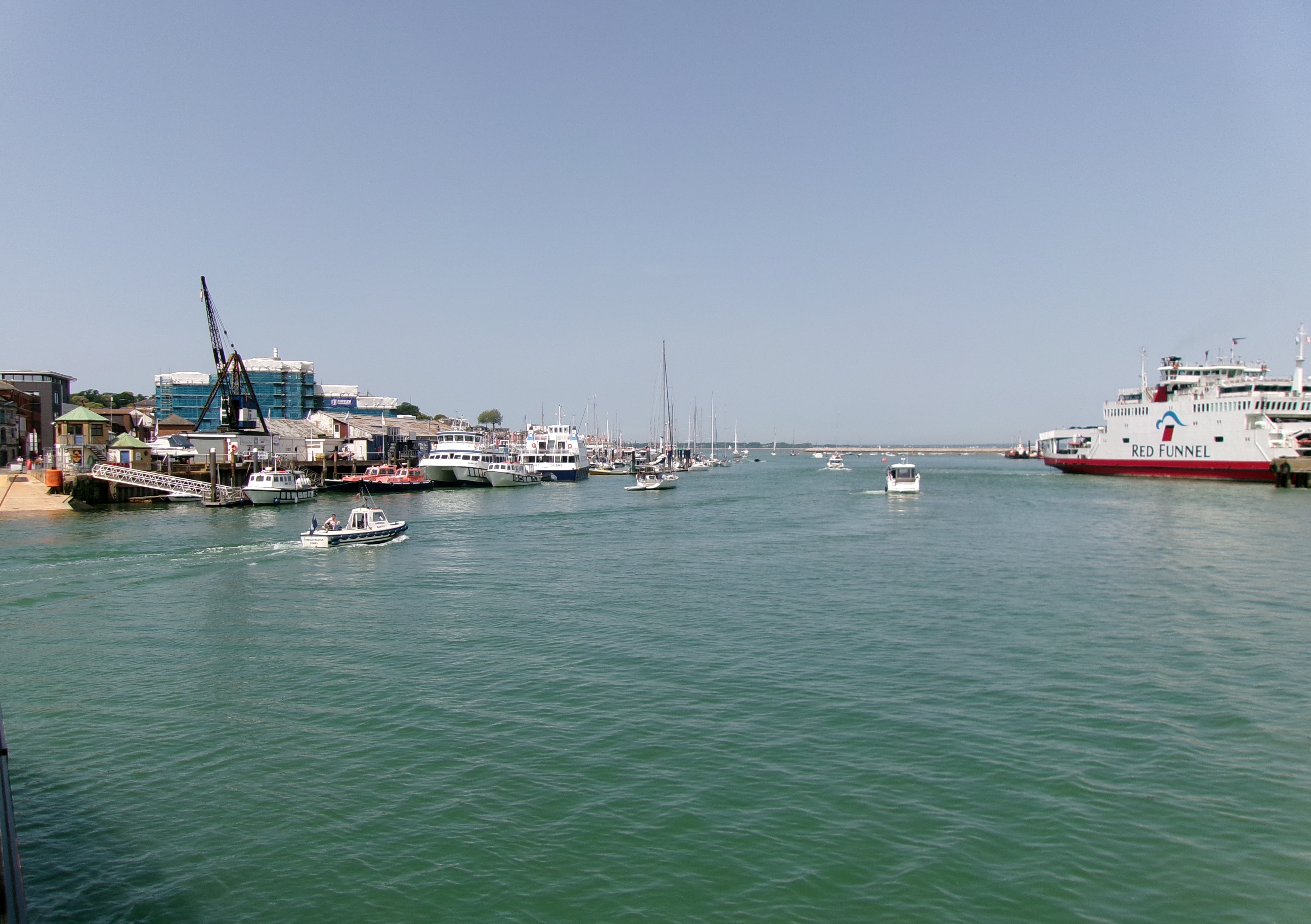 Ferries, sailing boats and waterfront buildings at Cowes Harbour