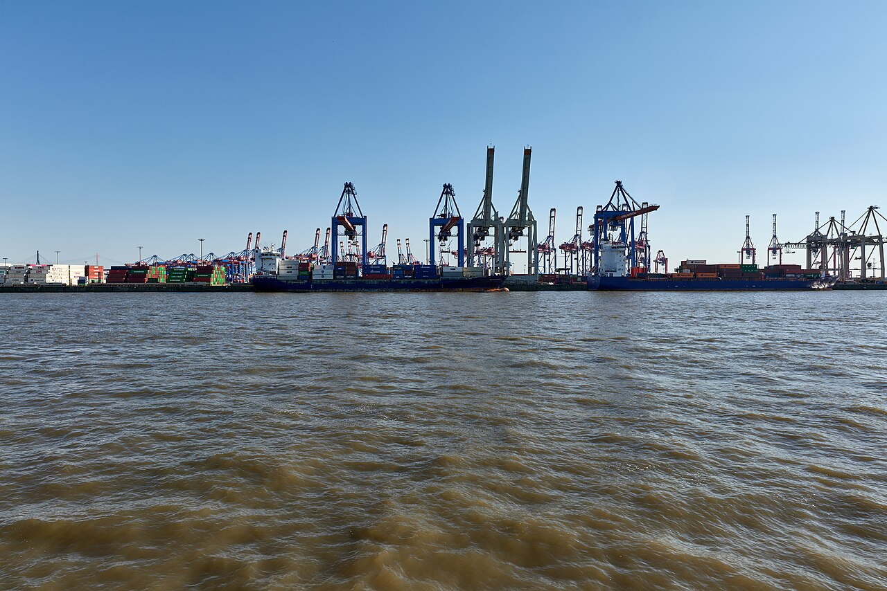 Container ships beneath quay cranes across the Elbe in Hamburg